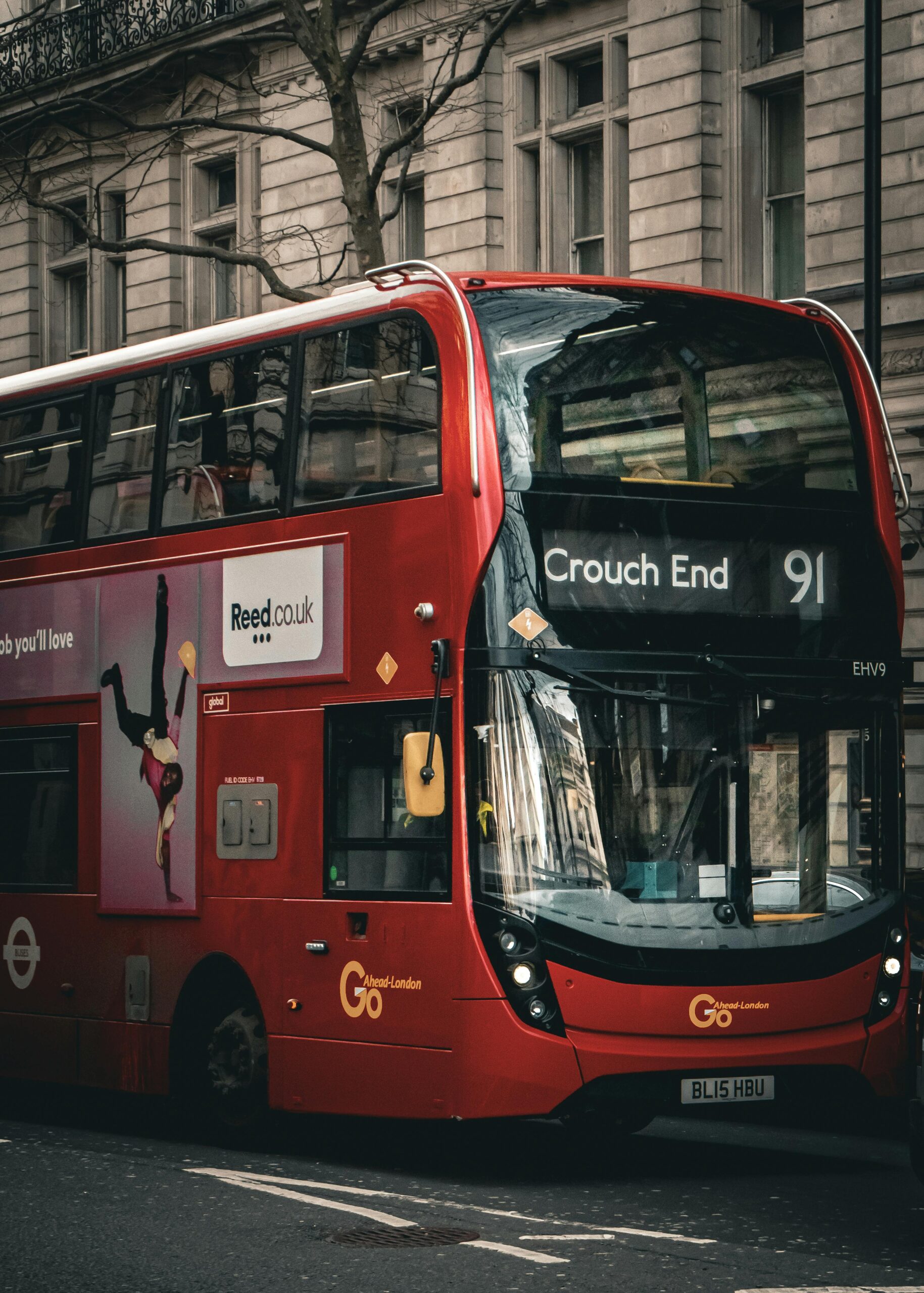 Classic red double-decker bus on London street showcasing Crouch End route number 91.